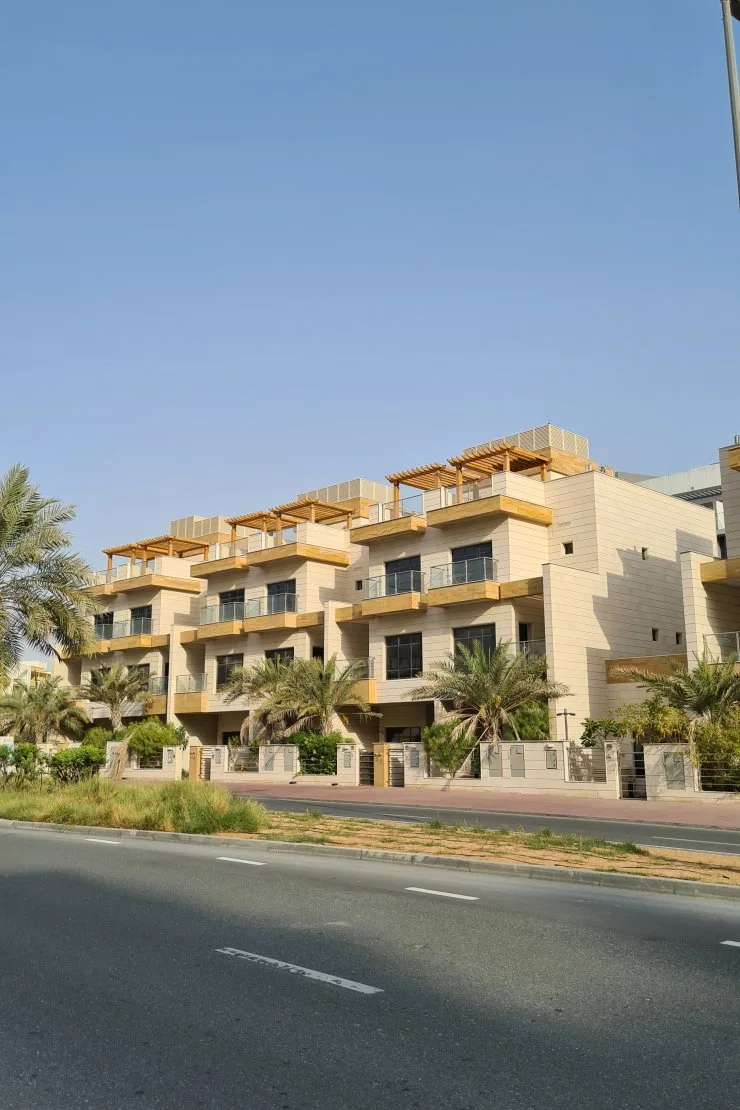 Townhouse block with timber balconies and rooftop pergolas
