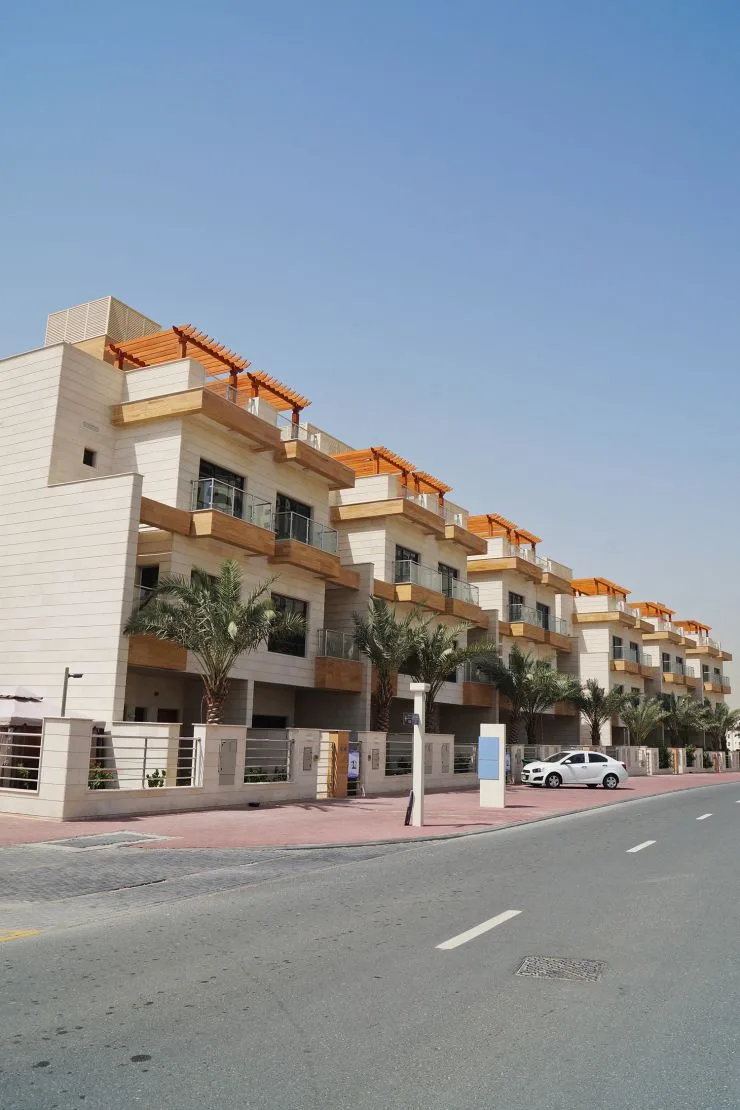 Street view of townhouse row with palms