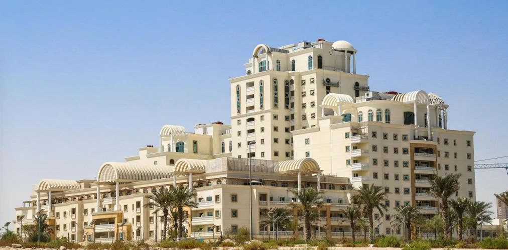 Wide view of stepped building with arched canopies