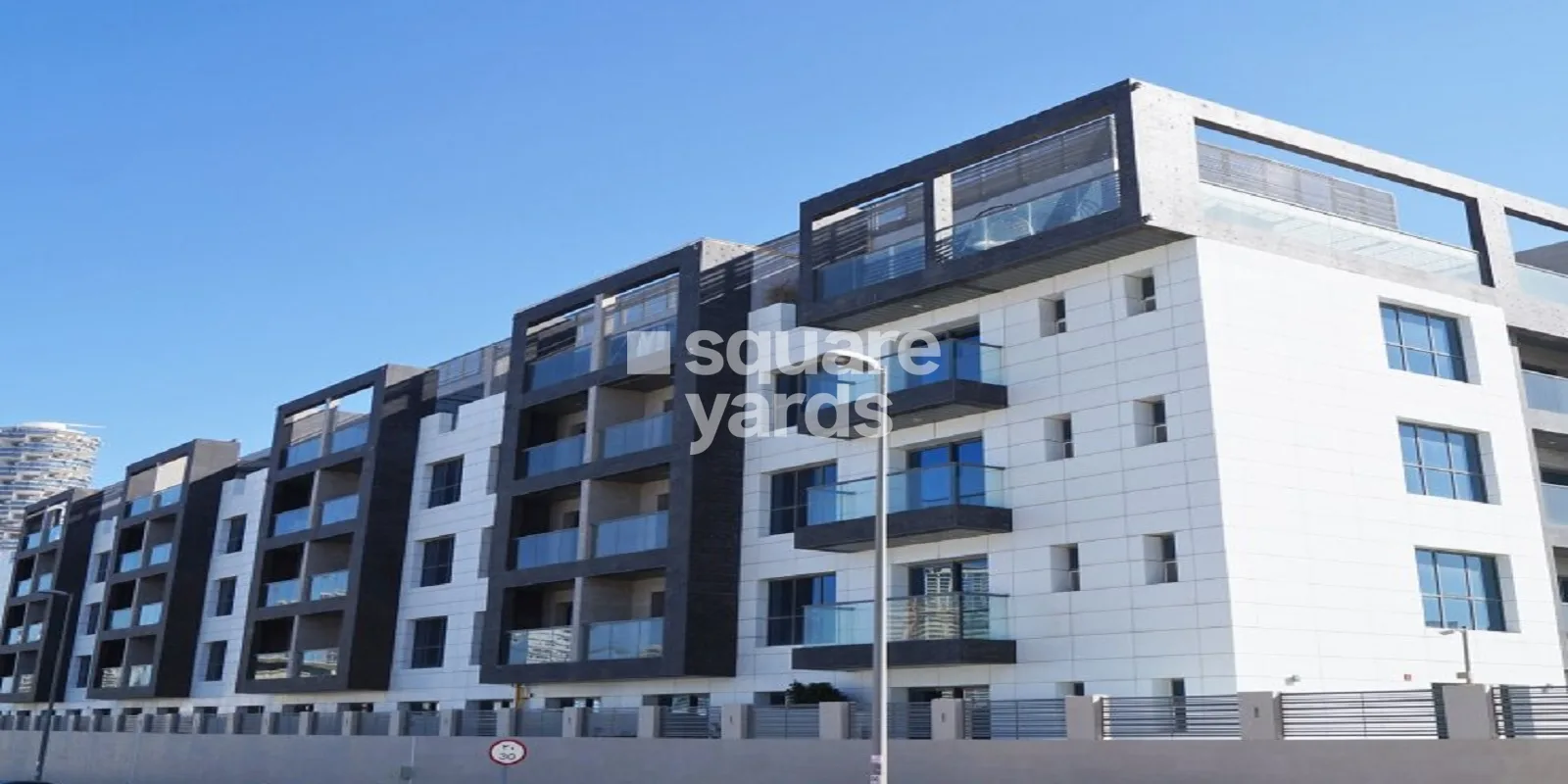 Long facade with dark balcony frames