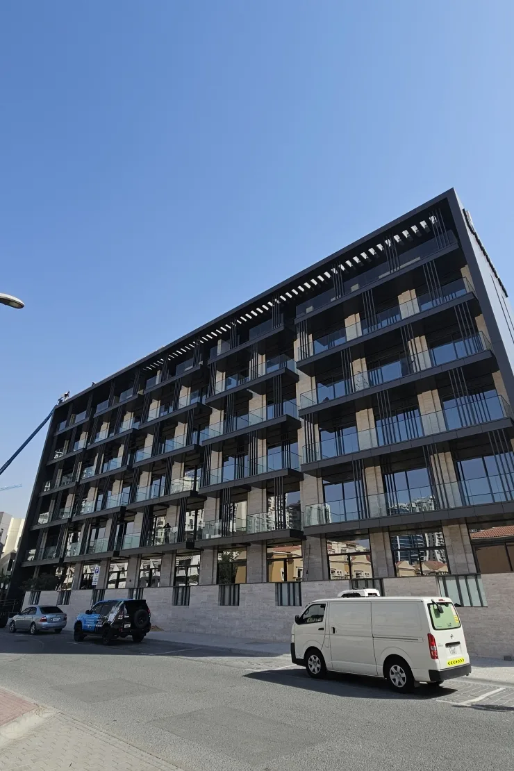Low-angle facade with balconies and dark frame