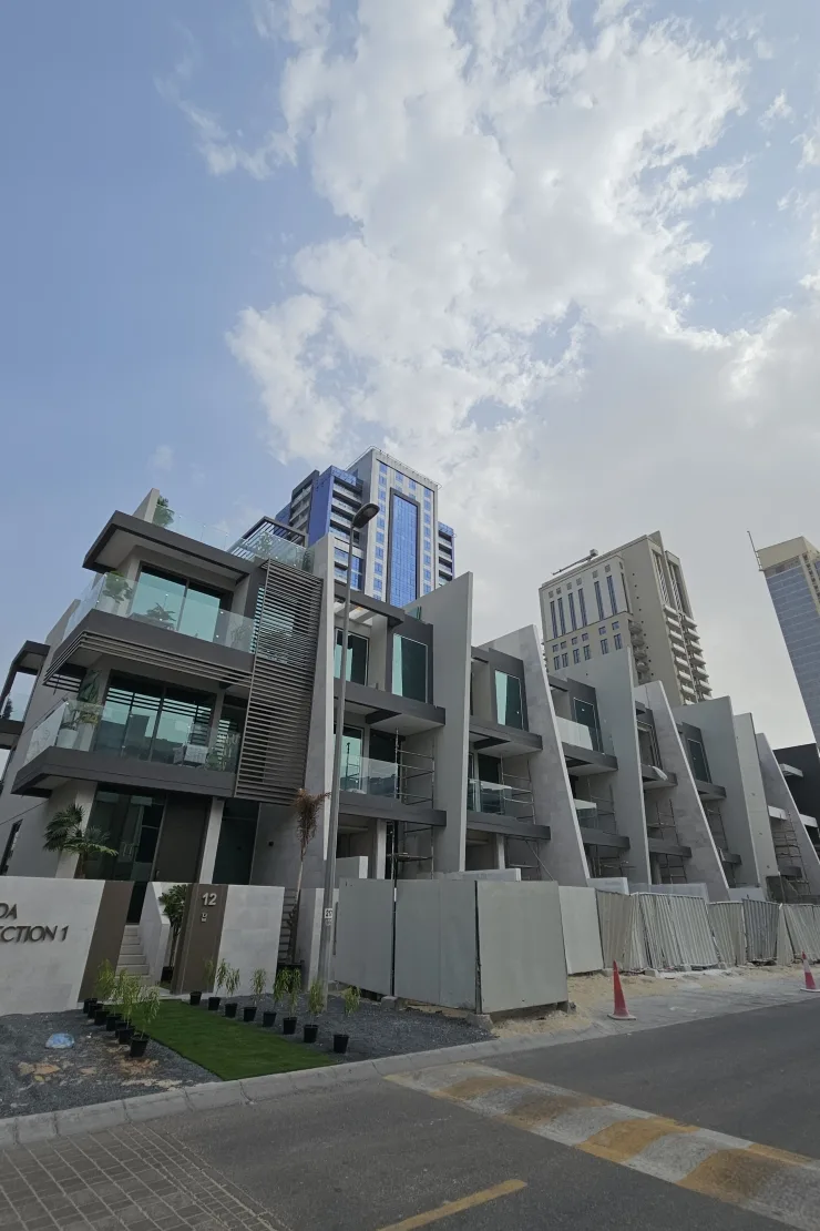 Stepped townhouse facade with unit 12 and signage