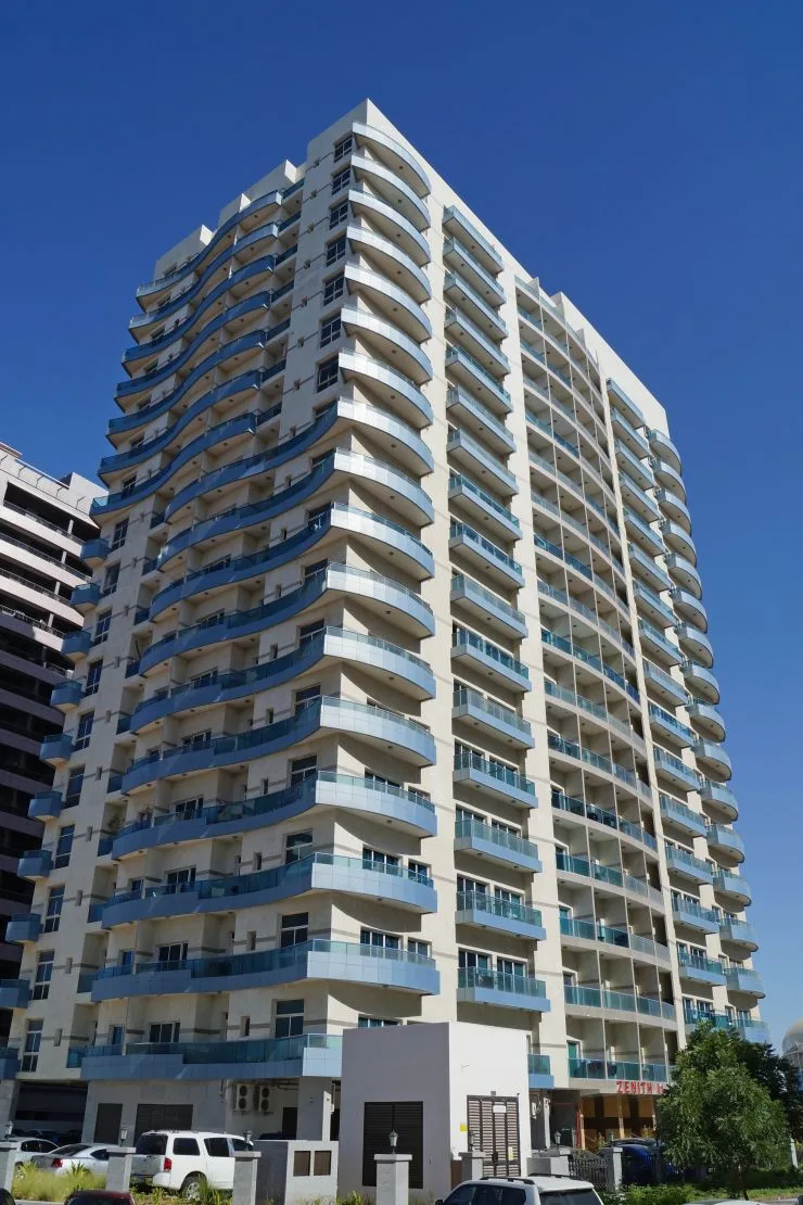 Tower corner view with curved blue balconies