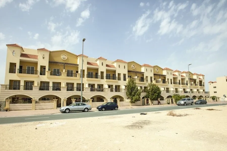 Terracotta-roofed Mediterranean-style low-rise block with arcaded ground floor
