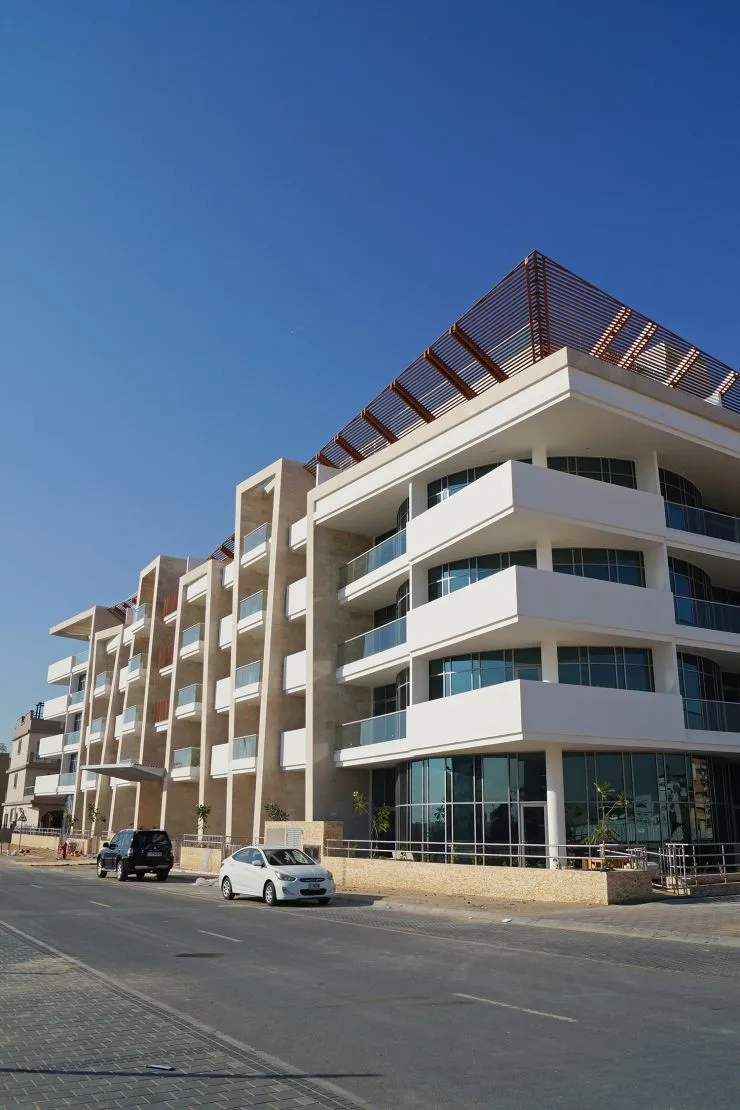 Street view of terraced facade and wooden pergola roof