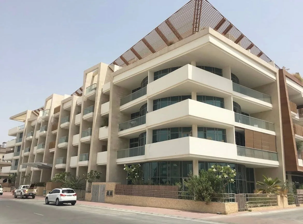 Corner view with balconies, pergola and landscaping