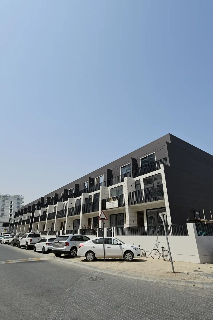 Row of dark and cream townhouses from the street