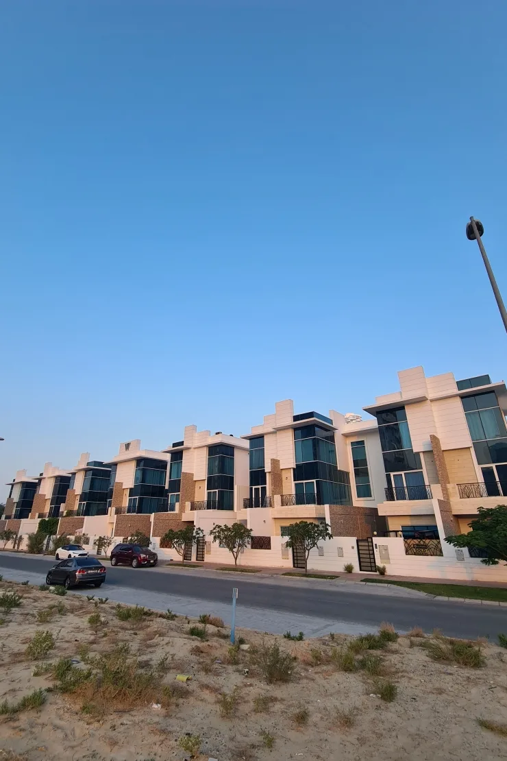 Long terrace of townhouses along street at dusk