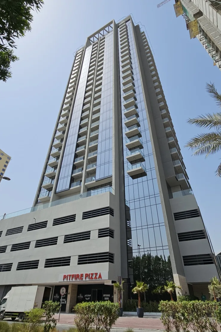 Full tower from street, balconies and glass facade