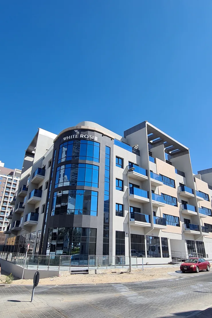 Corner view with White Rose signage, curved glass facade