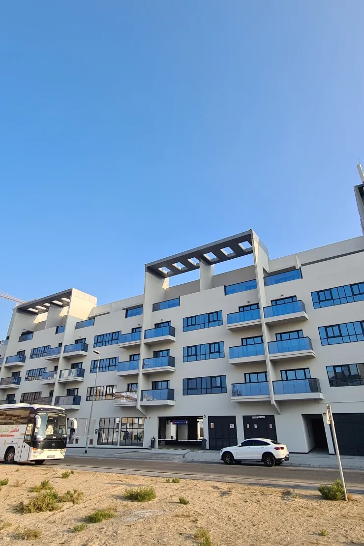 Full street facade with pergola crowns and blue balconies