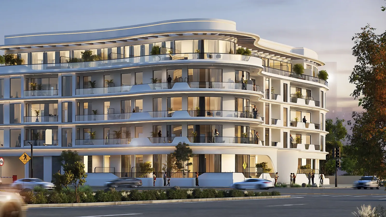 Curved white facade of the whole building at dusk