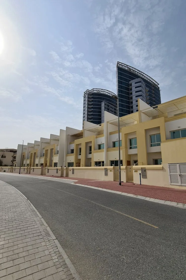 Row of yellow and cream townhouses along street