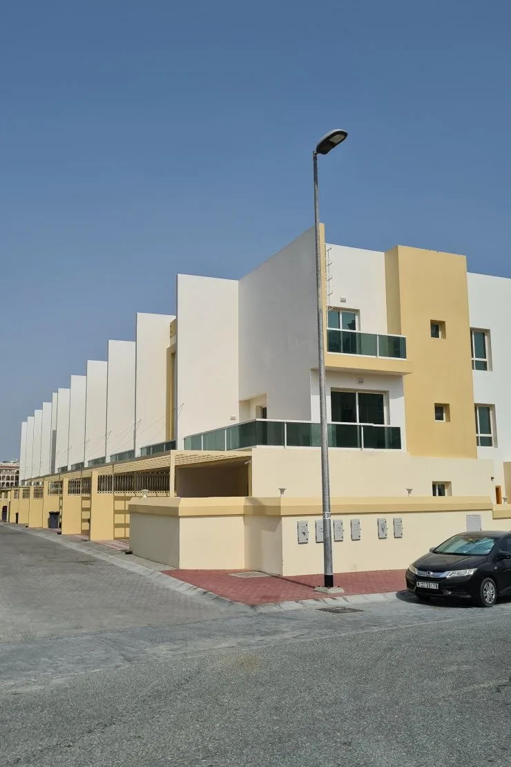 Corner townhouse block with white and yellow facade